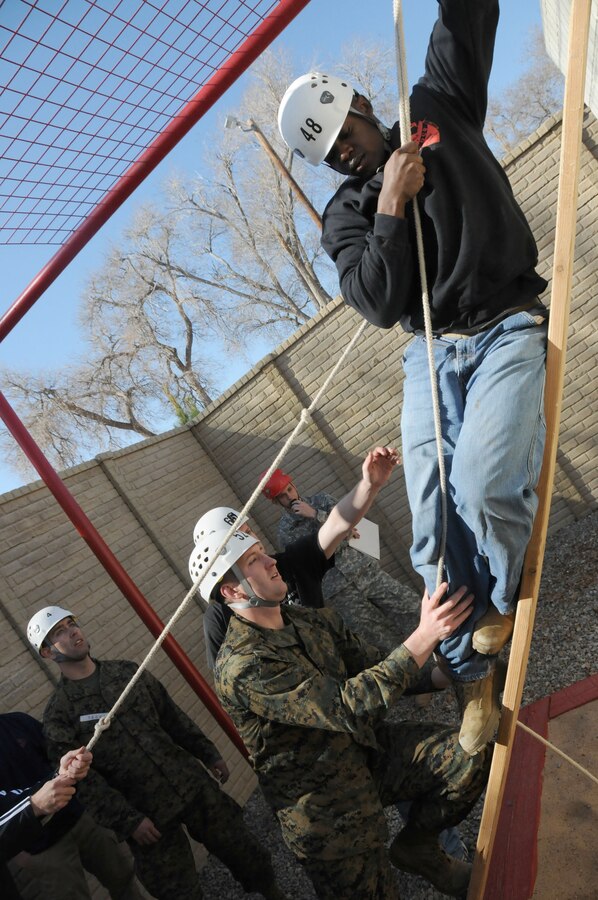 Officer candidates from Recruiting Station Albuquerque help Candidate Akeem J. Williams, 19, from Midlothian, Texas, navigate an obstacle Feb. 19 during a Leadership Reaction Course at the New Mexico Military Institute in Roswell, N.M. Candidates took part in the course to hone their leadership abilities in preperation for Office Candidate School. The course features multiple obstacles designed to sharpen leadership and problem-solving skills, as well as mental and physical agility.